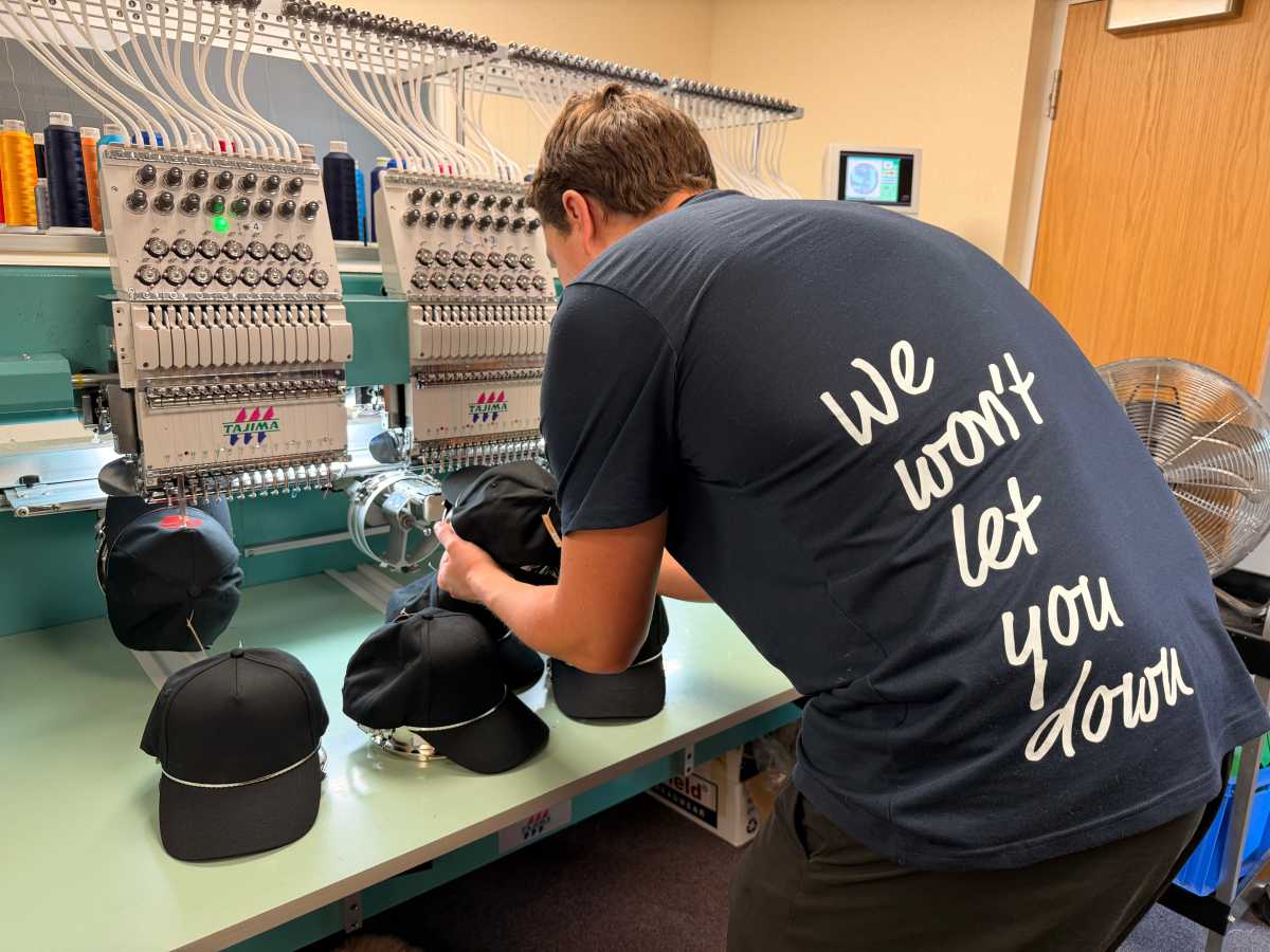 Embroidering caps on a multi-head machine in the SP Workwear workshop in Maidenhead