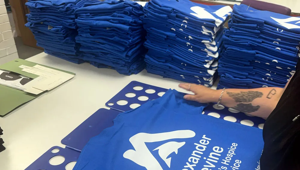 Folding printed t-shirts ready for packing